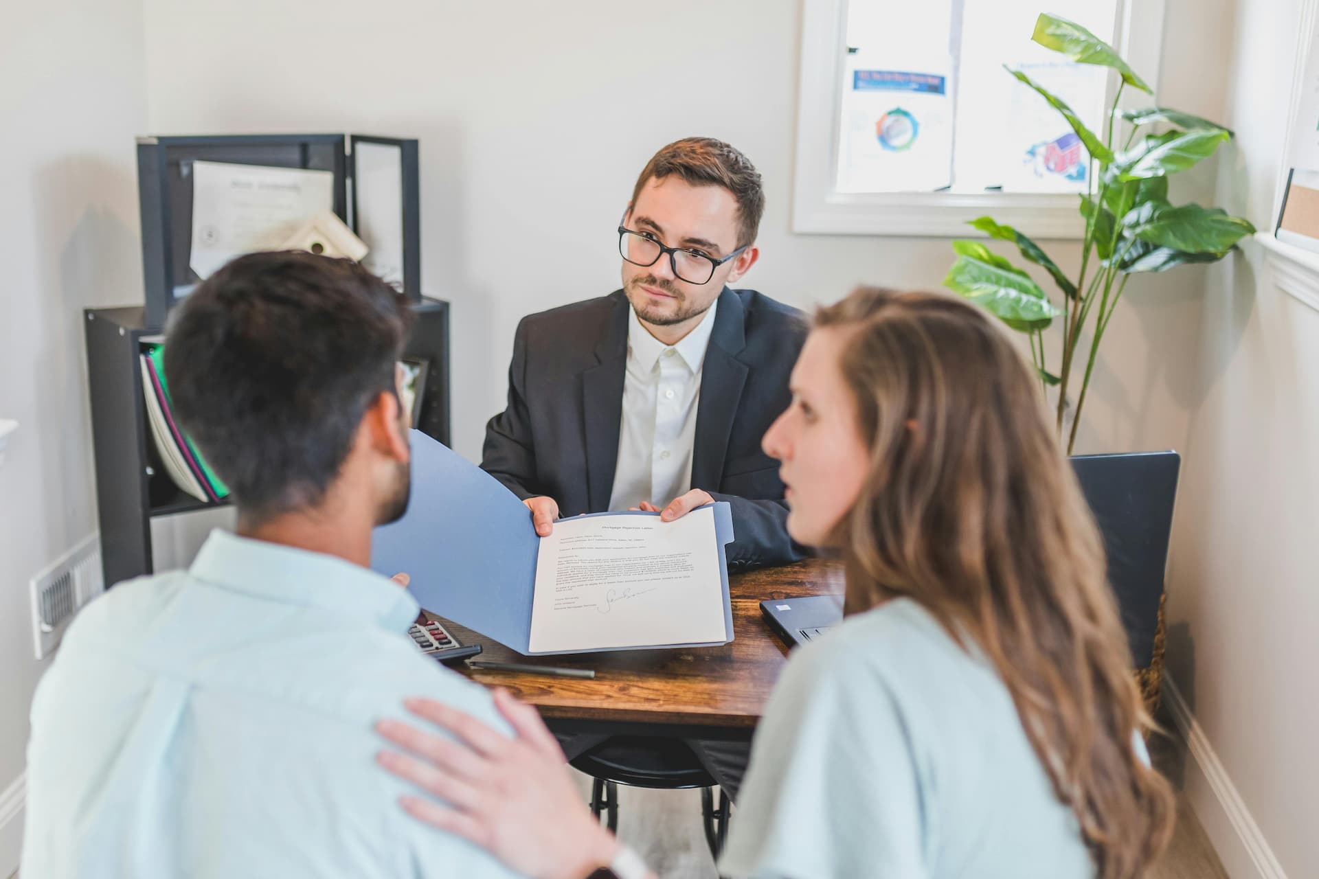 Couple discussing and preparing to sign a prenuptial agreement