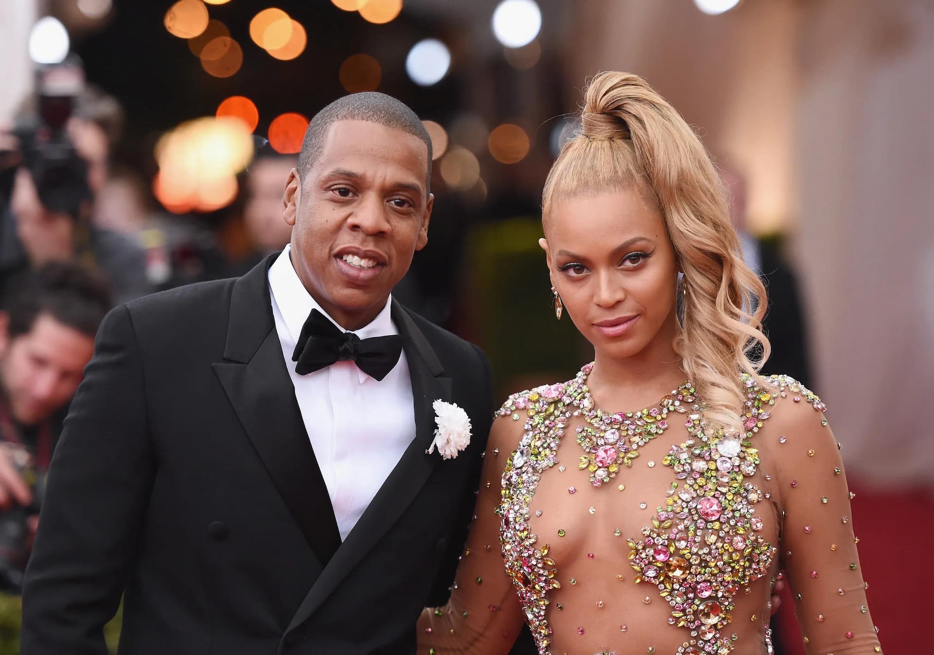 Jay-Z and Beyoncé posing elegantly on the red carpet, a power couple showcasing their iconic style, emphasizing the importance of financial planning and prenuptial agreements for high-profile marriages.